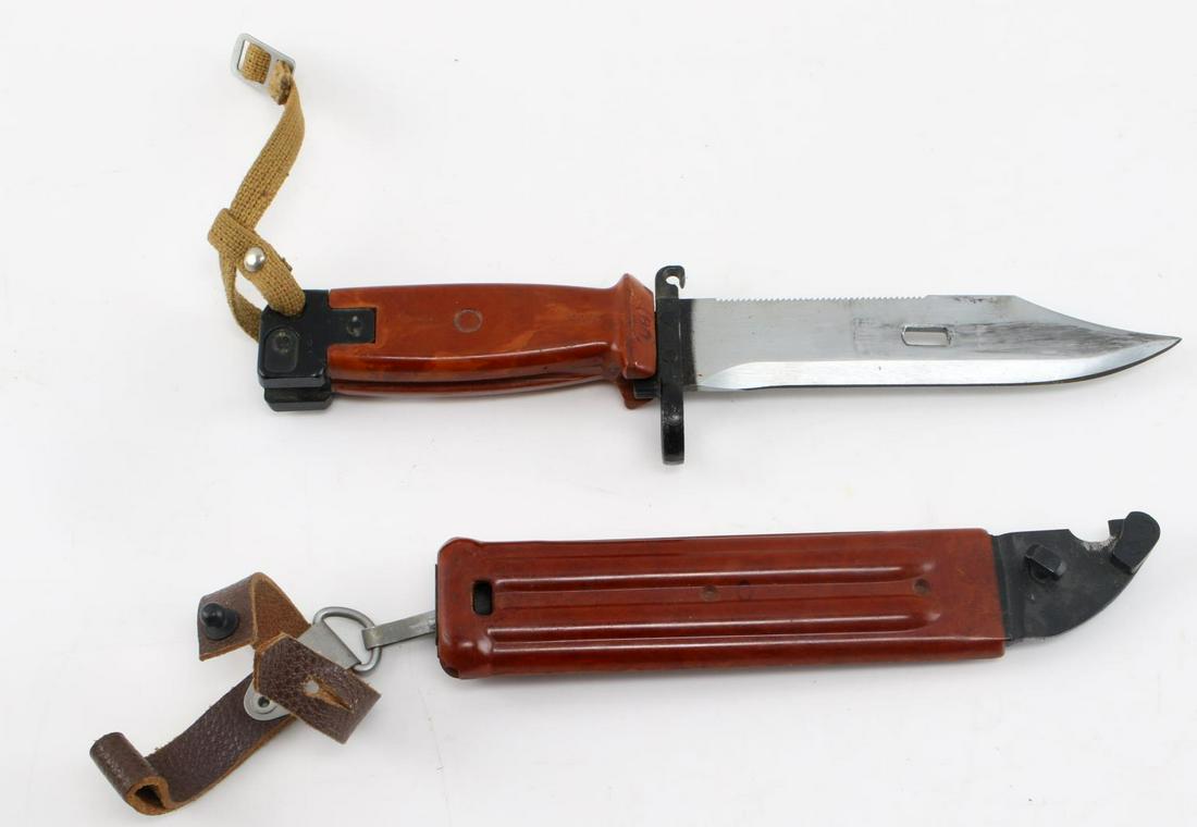 SOVIET AK 47 BAYONET IN SHEATH AND FROG: with blade measuring 6 inches and 11 inches overall. Bakelite handle etched with "4 1/2" and ricasso stamped "M" on "BO" on reverse size. Sheath is also bakelite with leather frog. Unauthenticated, so