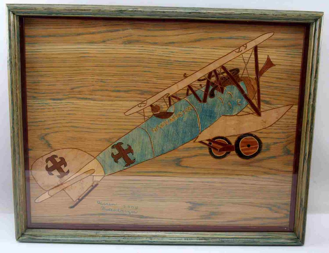 WOOD MOSAIC ART PIECE AVIATION HAWKMEISTER PLANE: Framed wood art piece showing Hawkmeister plane. Note from the artist on reverse identifies the amount of pieces and woods used. Signed and dated on front. Last name is illegible and first is Darren. 