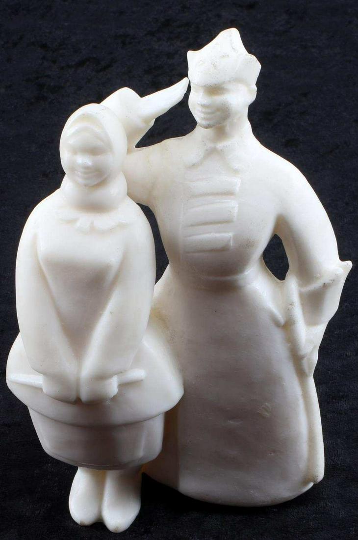 RUSSIA CIVIL WAR SALUTING SOVIET WAX FIGURE: Carved wax figure measuring 7 inches by 4 inches of Russian Civil War era (1917-1922) Soviet cadet wearing overcoat, Budenovka hat and sword in a saluting pose while a smiling wife dressed in peasant 