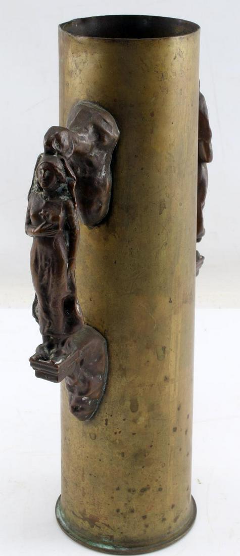 LARGE TRENCH ART PIECE WITH NUN BRONZE HANDLES: Stands 12 3/8 inches tall. Soldered bronze handles depicting nun with cross at chest. Very good condition.