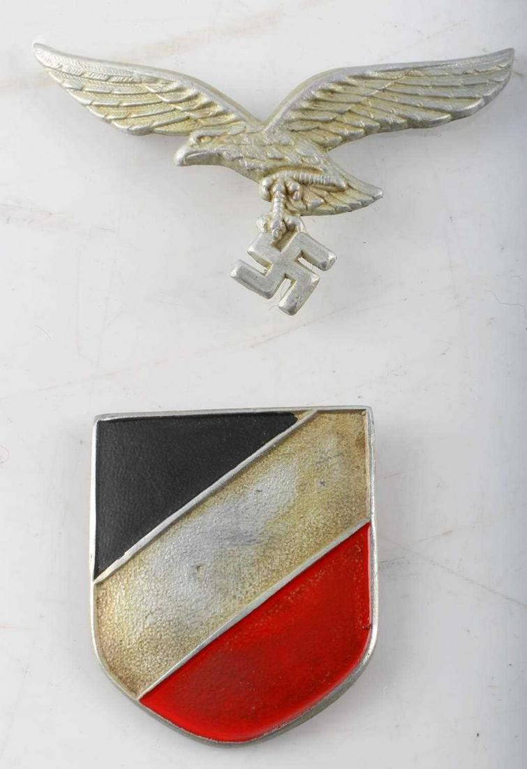 WWII GERMAN 3RD REICH LUFTWAFFE PITH HELMET SHIELD: WWII German Third Reich Luftwaffe Pith Helmet Shield. The Eagle and National Shield are placed on a plastic backing. Two prong construction on the rear. There is a patina on the rear. Good condition. 