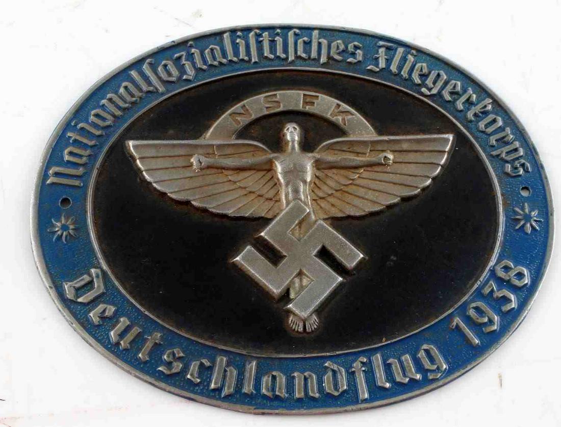 WWII GERMAN 3RD REICH 1938 DEUTCHLAND FLIGHT BADGE: WWII German Third Reich 1938 NSFK Deutchland Flight Badge. Oblong shape. Measures 3.75 by 3 inches. Some finish loss is present on the front, oxidation on the rear. Very good condition. Unauthenticate
