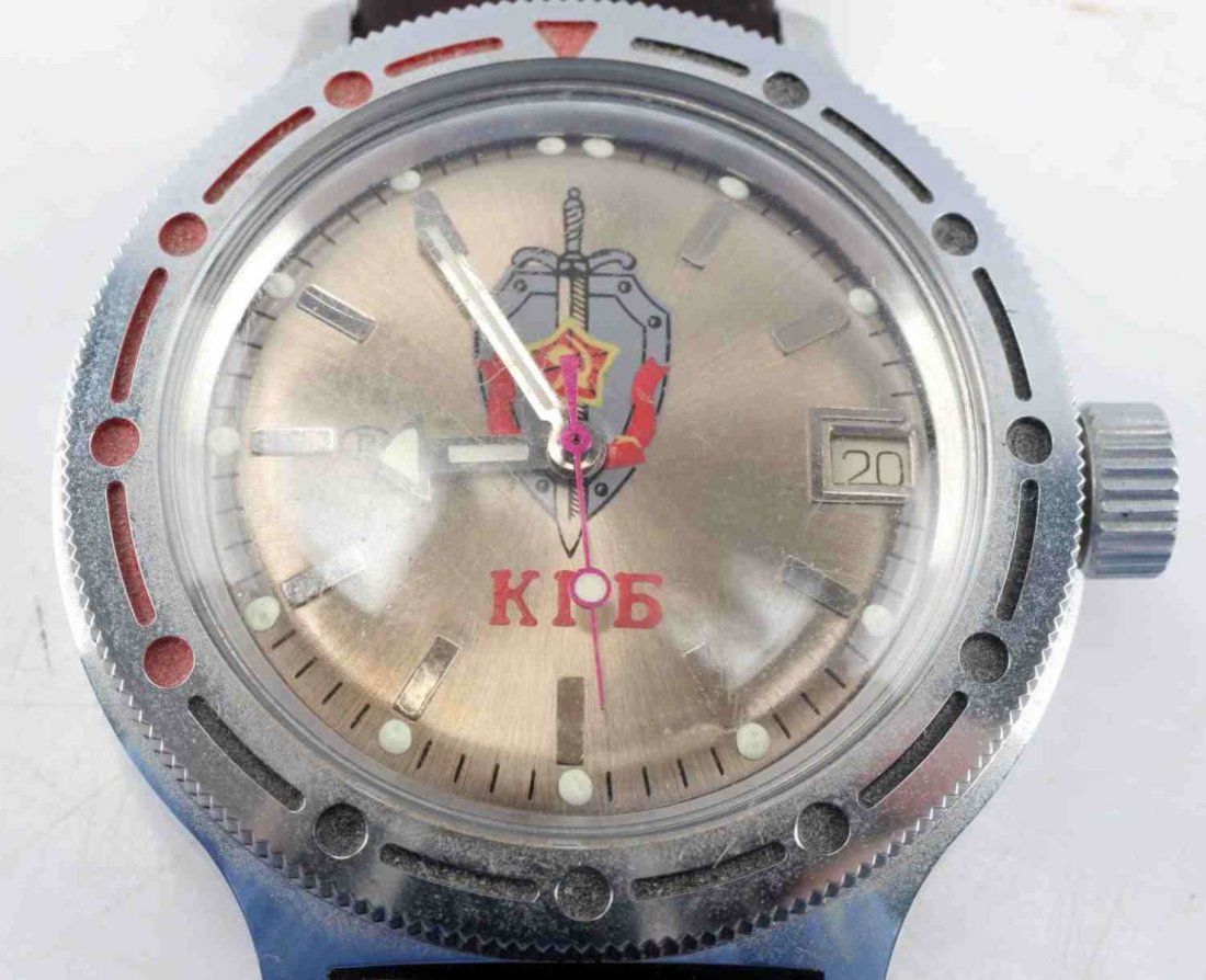 RUSSIAN KGB SELF WINDING WRISTWATCH: Russian KGB styled self-winding watch. Metal alloy construction, Russian script for KGB on face, with leather wrist band. Slight wear on back of strap near pin, overall good condition. Unauthenticated