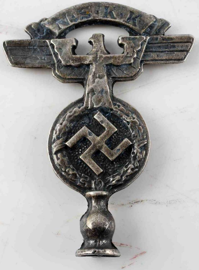 WWII GERMAN THIRD REICH NSKK FLAG POLE TOP: German WWII NSKK flag pole top most likely for car size flag. Measures 3 inches by 2 inches Has letters NSKK Stamped at top signifying it was representing the National Socialist Motor Korps. Very smal
