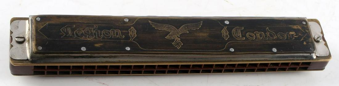WWII GERMAN 3RD REICH LEGION CONDOR HARMONICA: German WWII Legion Condor Harmonica. Measures 7 inches long by 1 inch wide. Harmonica has inscription which reads "Legion Condor" Surface has some spots with wear/discoloration. Plays well. Overall, v
