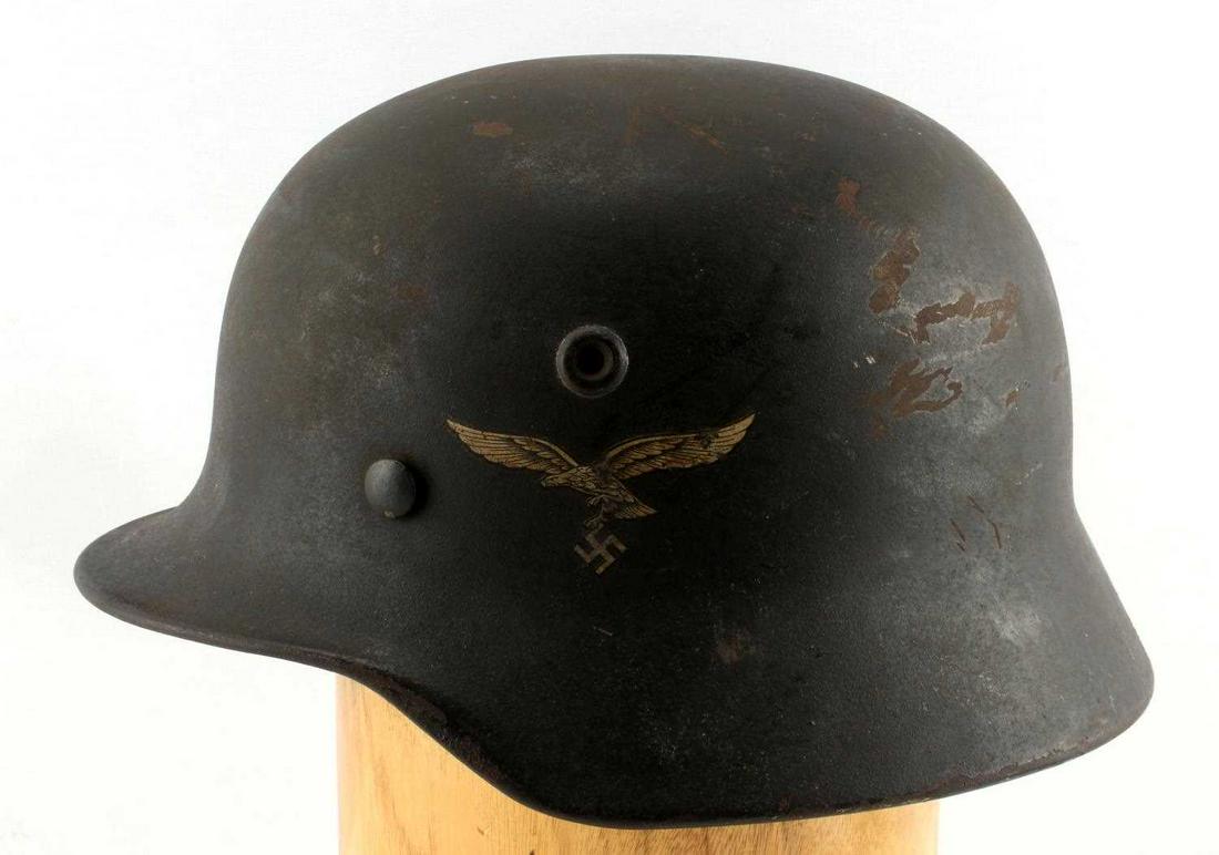 WWII GERMAN LUFTWAFFE HELMET WITH INTERIOR LINING: WWII German Luftwaffe Helmet With Leather Interior Lining. Leather chinstrap is broken, only a piece of it remains attached. Interior leather lining of the helmet is ripped and cracked. It is stamped 