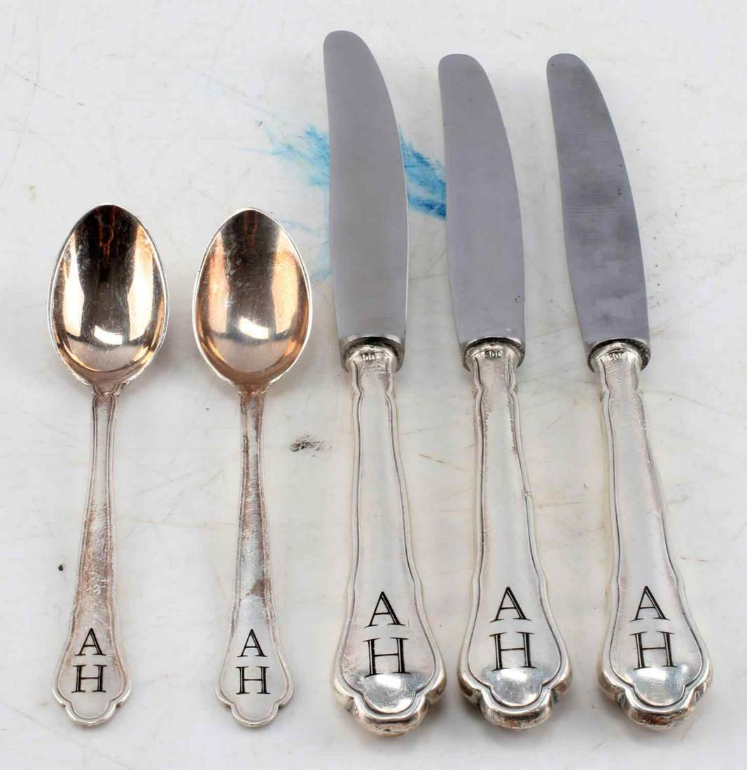 SILVER WWII THIRD REICH HITLER TABLEWARE LOT OF 5: WWII German Third Reich tableware set 3 table knives and 2 spoons. Knives measure 7 inches in length, .65 inches wide. Blades are stamped with "Rostfrei" and handles feature initials "A H". Spoons mea