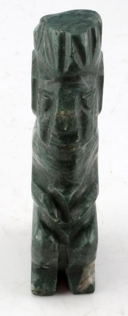 NATIVE AMERCIAN CARVED CHALCEDONY HUMAN EFFIGY: Native American carved chalcedony human figure. The figure is featured in a seated position, and carved from nicely marbled green chalcedony stone. Measures 3.50 inches tall, 1.50 inches in depth, and