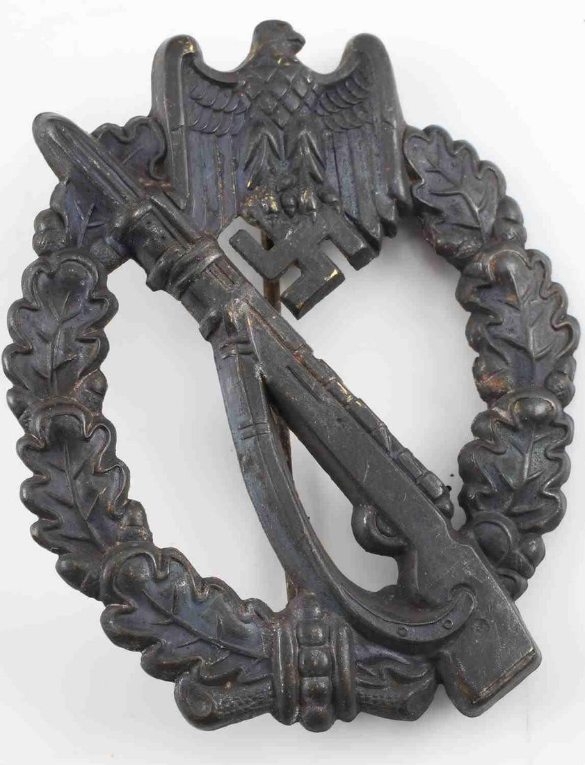 WWII GERMAN SS WEHRMACHT INFANTRY ASSAULT BADGE: German WWII Army Bronze Infantry Assault Badge. The front shows a Mauser K-98 rifle in the center with a German eagle clutching a swastika in his talons at the top. Both are surrounded by an oval oak 