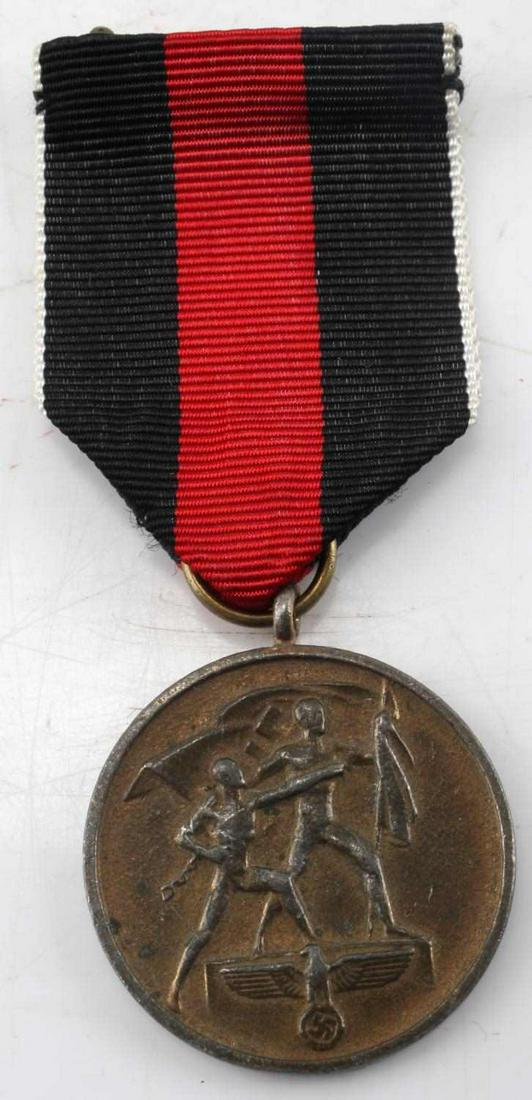 CZECHSLOVAKIAN ANSLUSS ANNEXATION MEDAL W RIBBON: Medal for annexation of Czech into the Reich October 1, 1938. Black and red ribbon with white border. Very good condition. This lot has a reserve.