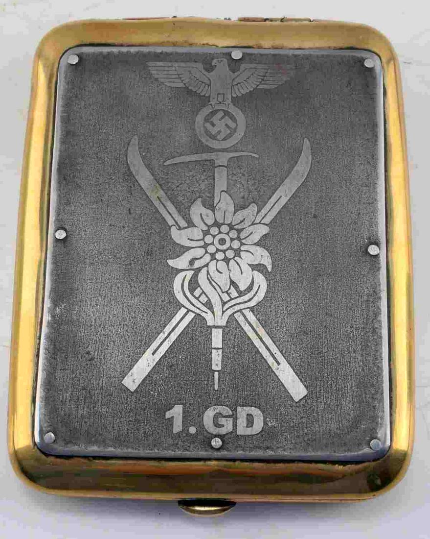 WWII GERMAN MOUNTAIN TROOPS CIGARETTE CASE: WWII German 3rd Reich Mountain Troops cigarette case. Metal alloy construction, front features metalic finished face with Mountain troops insignia, imperial eagle, and 1.GD engraved. Reverse features