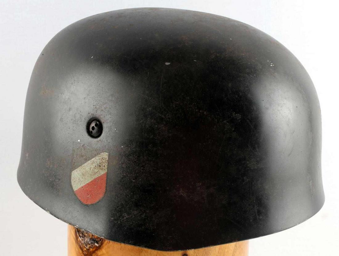 WWII GERMAN PARATROOPERS DOUBLE DECAL HELMET: Painted black steel construction, Reichsadler decal to left ear and shield decal to right ear. Leather liner with holes and stamped Kopfweite Gr. 60, Stahlhaube Nr. 68, light grey leather strap is wor