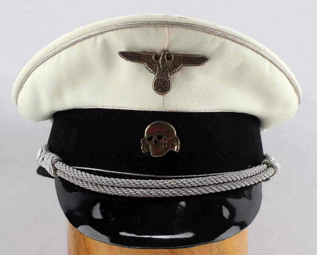 WWII GERMAN SS GENERAL OFFICERS SUMMER HAT CAP: White cloth hat with silver piping, eagle and Totenkopf cap insignia, grey chinstrap. SS RZM label to inside. Size 58. Some staining to top of cap, otherwise good condition. Unauthenticated, sold as i