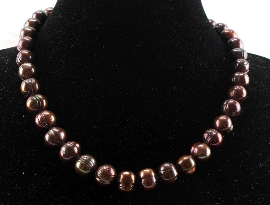 TAHITIAN BAROQUE PEARL NECKLACE W 14KT CLASP: Tahitian chocolate peal necklace with 14kt gold clasp, 11-12mm, chocolate color, characteristic baroque (irregular) body and bumpy surface, individually knotted, length 19 inches.