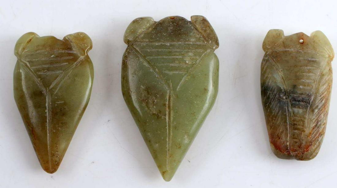 THREE CHINESE GREEN SOAPSTONE PENDANTS: Smallest measures 2.25 inches by 1.25 inches. Middle measures 2.5 inches by 1.25 inches. Largest measures 2.75 inches by 1.5 inches.