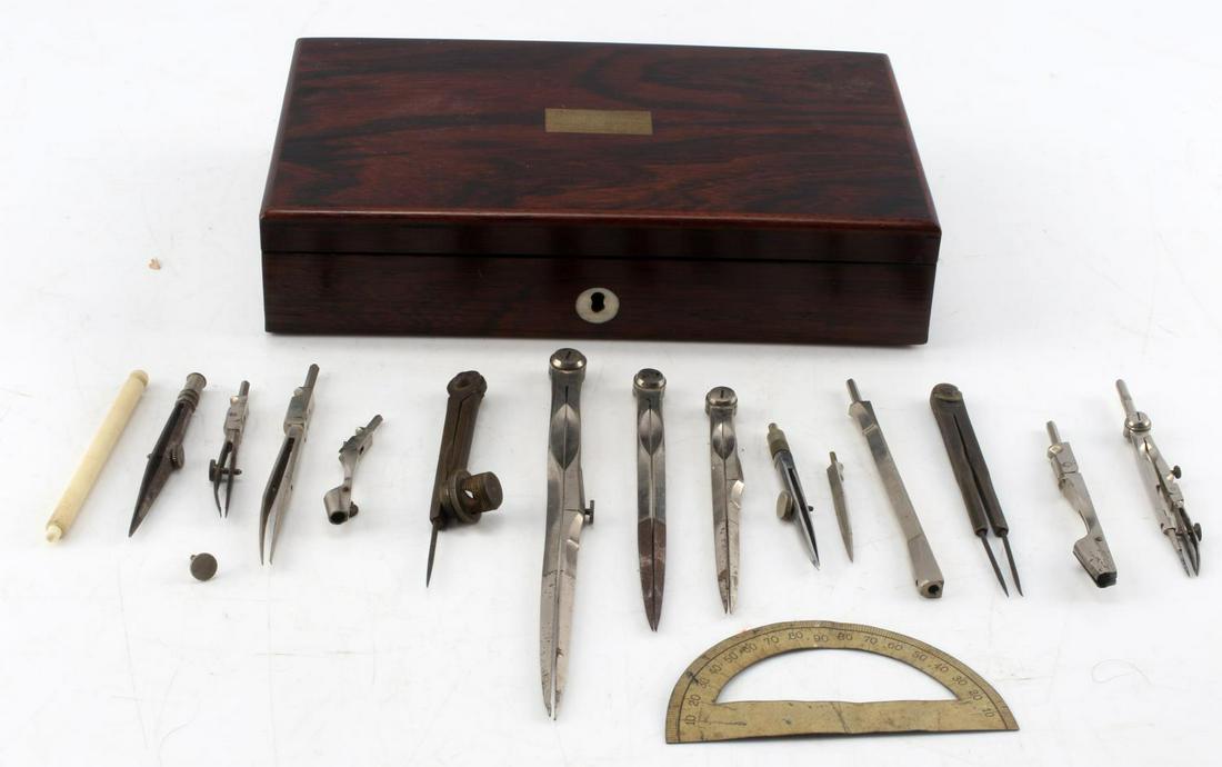 ANTIQUE DRAFTING TOOL SET WITH WOODEN CASE: 17 piece antique drafting tool set. Includes 1 bone handle, several scribe attachments, 6 compasses, and a wooden case. Case measures 1.75 by 8.25 by 5 inches. No visible maker's mark.