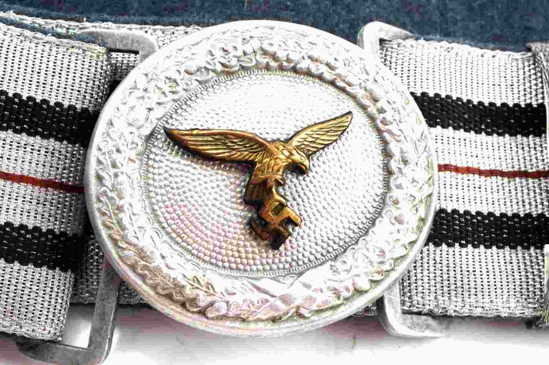 WWII GERMAN LUFTWAFFE BROCADE BELT AND BUCKLE: WWII German Luftwaffe Parade Style Belt and Buckle. Stamped with maker's mark "Ges Gesch." Gold Luftwaffe eagle emblem in the belt buckle is accentuated by black, red, blue, and silver stitching. Very