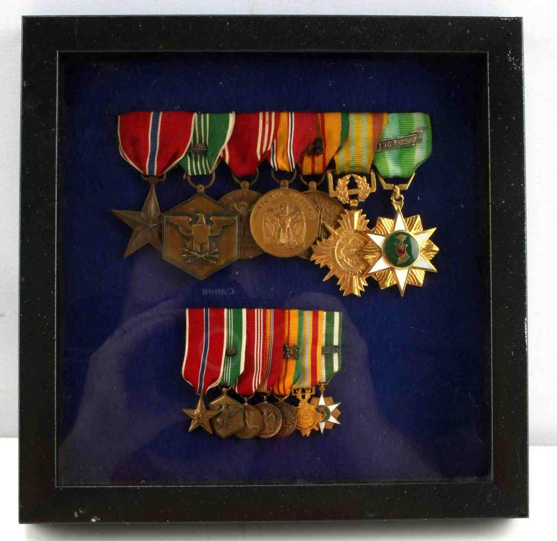 BRONZE STAR MERITORIOUS SERVICE MEDAL LOT OF SEVEN: Framed 9x9 inch Vietnam Era Meritorious Medal Lot of Seven. Pinned to a blue felt backing. Includes both US and Vietnamese commendation medals. US Bronze Star, US Good Conduct medal with 8 year oak le