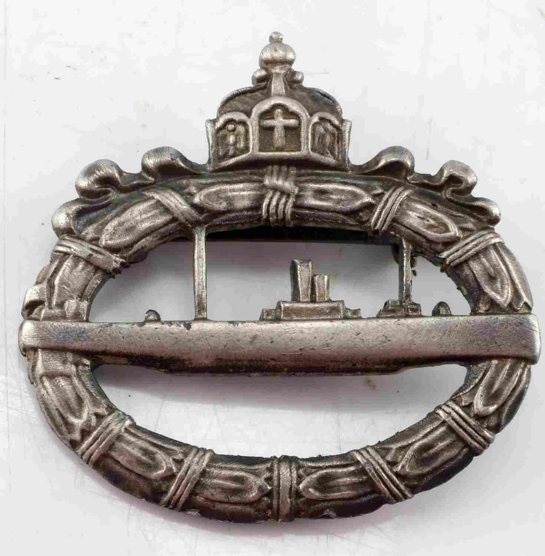 WWI IMPERIAL GERMAN U BOAT BADGE WALTER SCHOTT: WWI Imperial German U Boat Badge. Makers mark of "Walter Schott" on the rear. Broad style pinback. Slight pitting and color loss throughout the badge. Measures 2 inches long by 1.75 inches tall. Overa