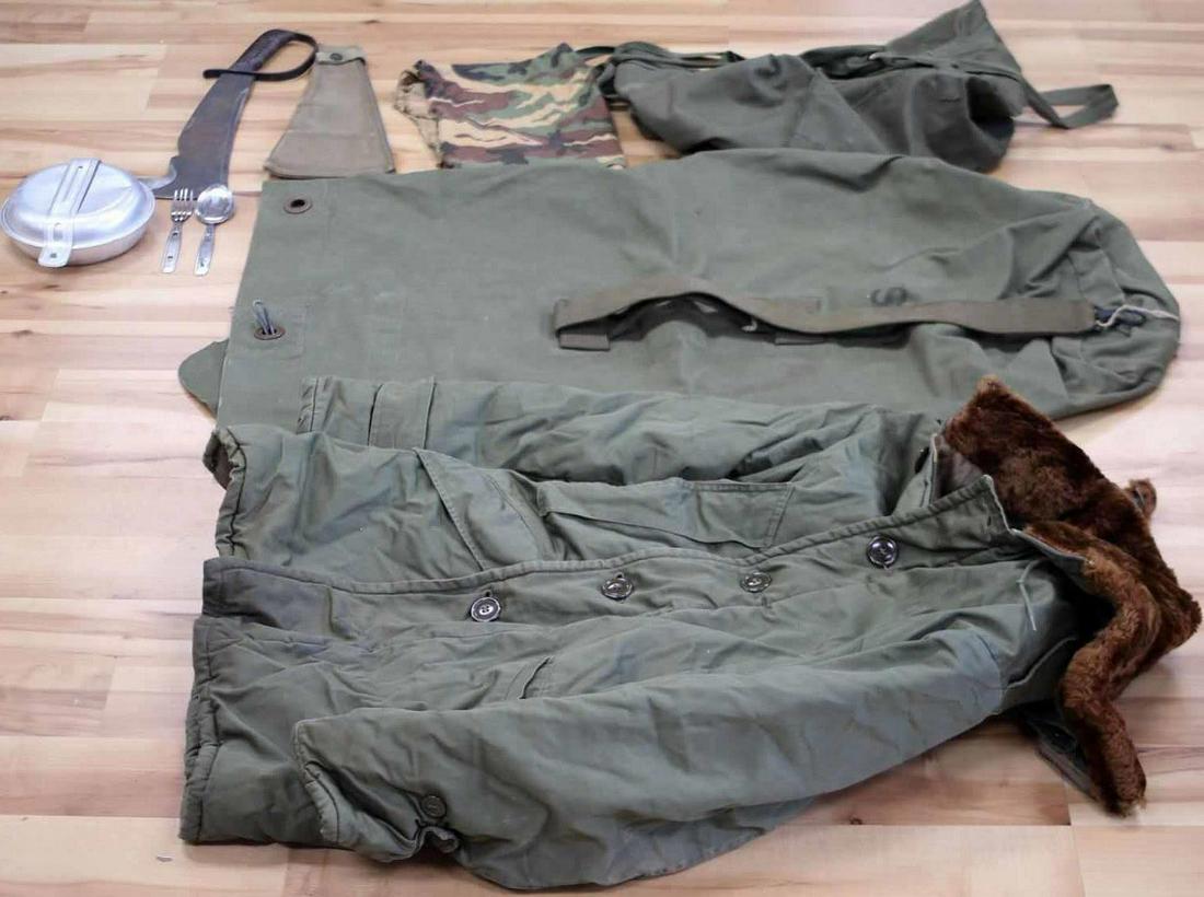 US MILITARY MIXED CONFLICT PARKA MESS KIT LOT OF 5: US Military Mixed Conflict Parka, Mess Kit, Mil-issued canvas bags and one Woodsman Pal Machete. The machete has a blade that measures 12 inches. There is a patina on the blade. Parka is Type B-9 and