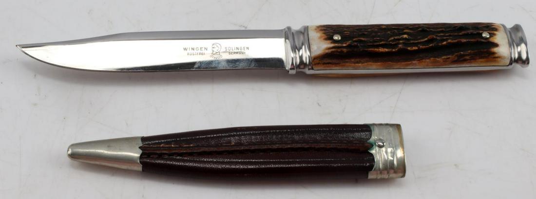VINTAGE GERMAN ANTON WINGEN KNIFE AND SCABBARD: Vintage Anton Wingen stag handled knife. Blade measures approx. 4 inches, and knife is over all 7.50 inches long. Handle is made from antler. Leather sheath with alloy accents. Good condition.