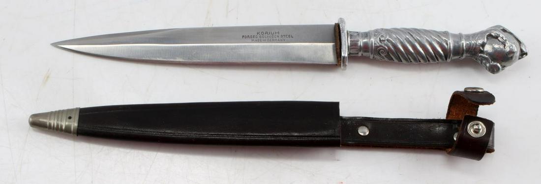 WWII GERMAN KORIUM SOLINGEN STEEL FIGHTING KNIFE: 6.25 inch sharp tip blade, marked Korium Forged Solingen Steel Made in Germany, leather washer, aluminum grip and eagle's claw pommel. Comes with leather sheath. Very good condition.