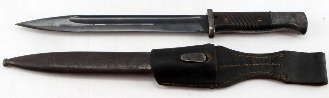 WWII GERMAN THIRD REICH K98 BAYONET: WWII German Third Reich K-98 Bayonet, with sheath and frog. Bayonet features bakelite handle grips, Waffenampt stamp at pommel, and measures 15.25 inches long. Includes non numbers matched sheath and 