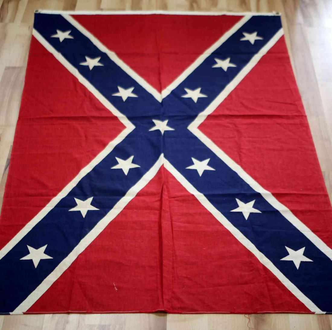 VINTAGE LARGE US CIVIL WAR CONFEDERACY REBEL FLAG: Vintage Large US Civil War Confederacy Rebel Flag. Measures 57 by 34 inches. Has some discoloration due to the age of the flag. Two suspension holes to hang or fly the flag. Overall, good condition.