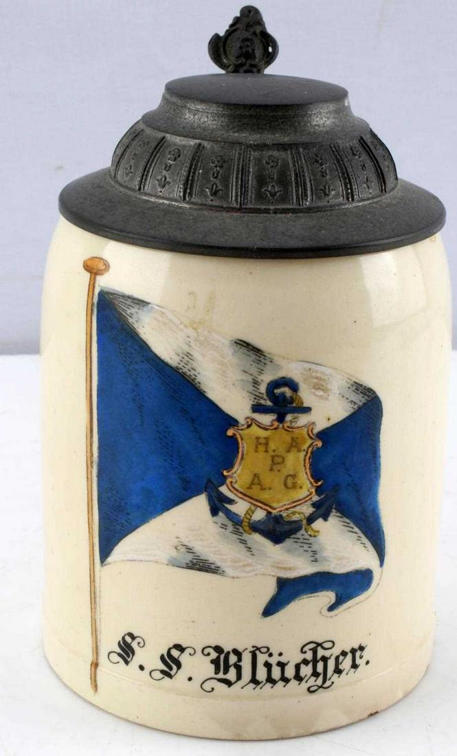 ANTIQUE SS BLUCHER HAMBURG AMERICA BEER STEIN: Antique beer stein with hand painted nautical flag and Hamburg-America line ship title "SS Blucher." Stein measures approx. 5.50 inches tall. Ceramic construction with metal alloy lid. Small chip on b