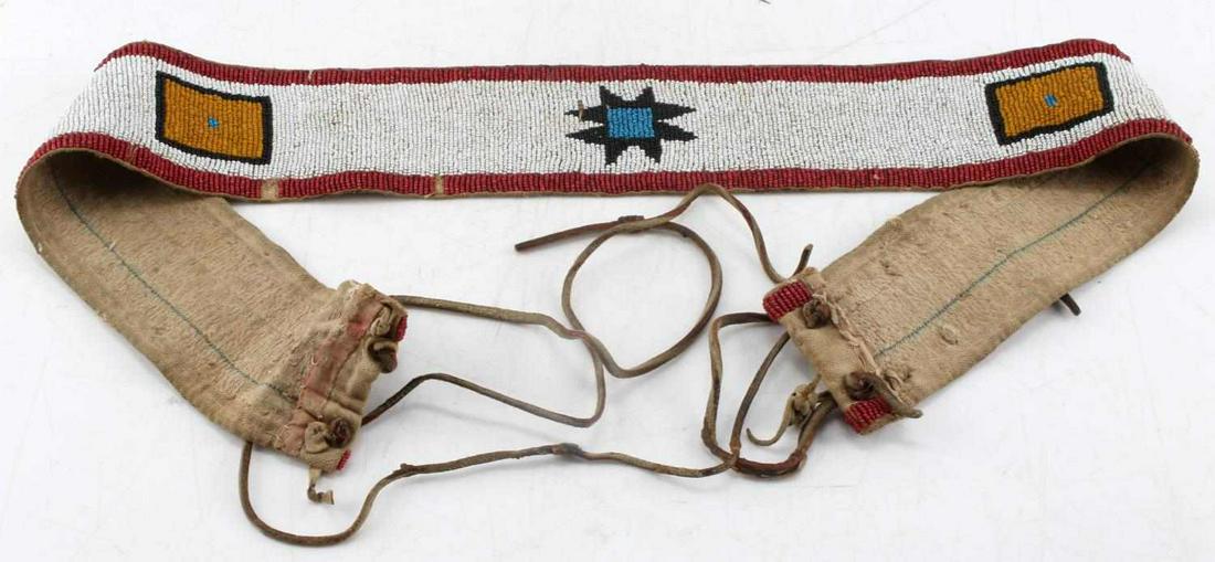 ANTIQUE NATIVE AMERICAN BEADED CANVAS BELT: Antique Native American beaded belt. Measures 34 inches long and 2.50 inches wide. There is slight bead loss, mainly around the edges. Shows signs of age, slight staining in places, but overall good c