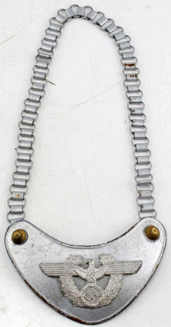 WWII GERMAN THIRD REICH POLICE GORGET WITH CHAIN: WWII German Third Reich police gorget.. Measures 6.50 in by 3.25 in. Chain is 25in long. Has some light oxidation around lip, along with signs of age. Overall good condition.