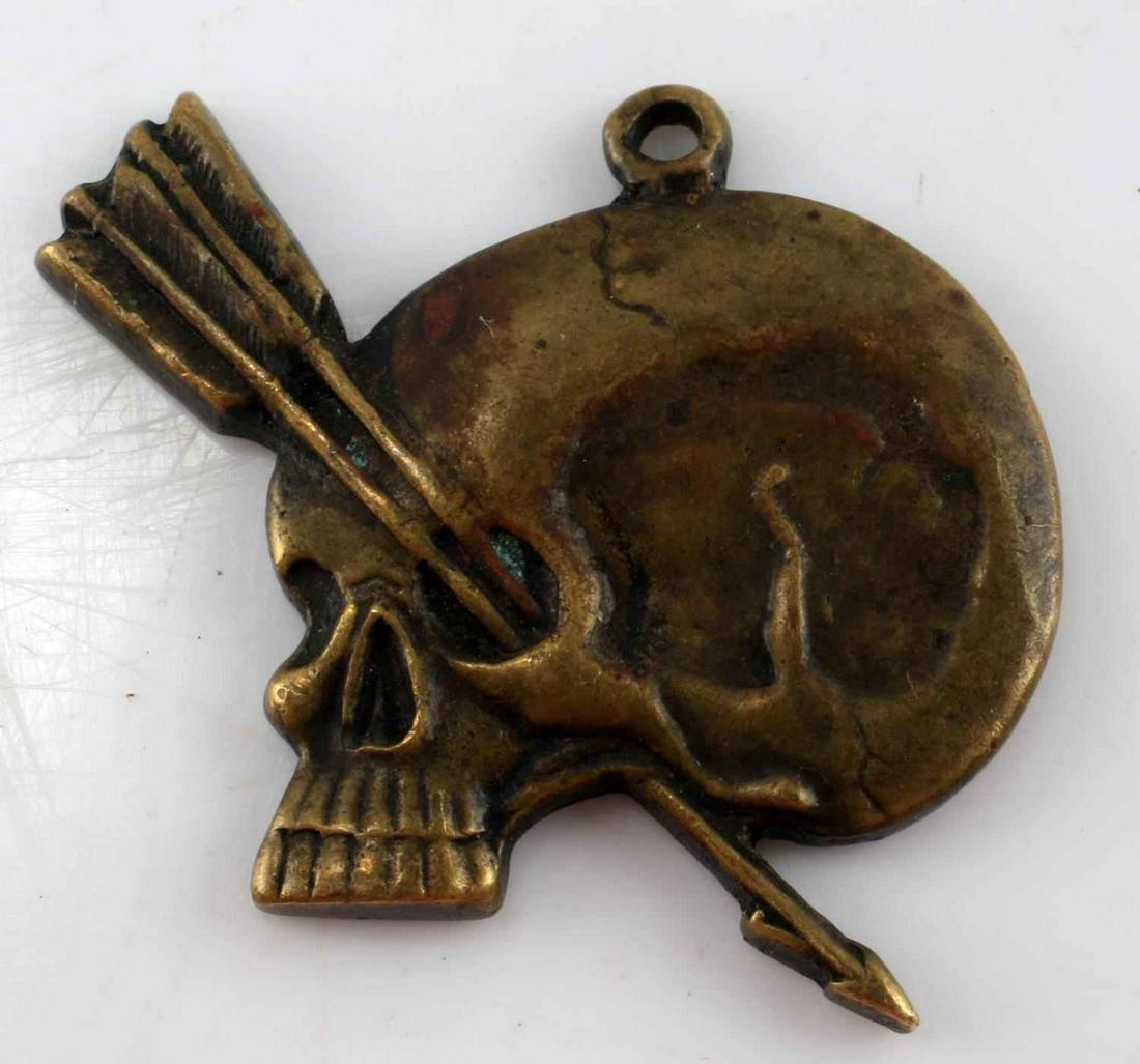WWII GERMAN THIRD REICH HJ MARKSMAN SKULL PENDANT: WWII German Third Reich Hitler Jugend Marksman Totenkopf Skull Pendant. Composed of brass, some oxidation in the left eye near the arrows. Oak leaf style motif on the rear with some visible pitting. T