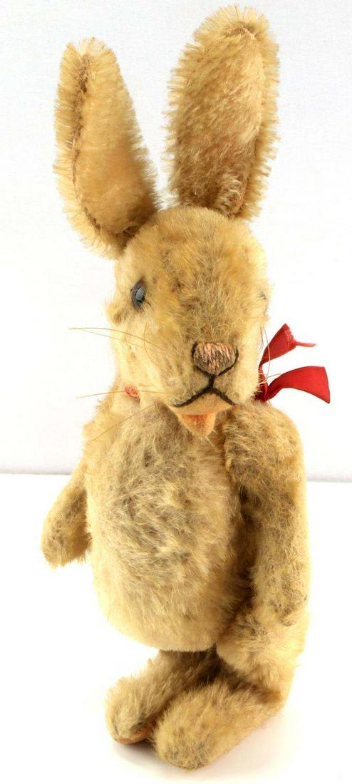 STEIFF 10 INCH TALL MOHAIR BUNNY WITH RED RIBBON: 10 inch tall Steiff antique mohair bunny with red ribbon, jointed arms and legs, glass eyes, and an open mouth.