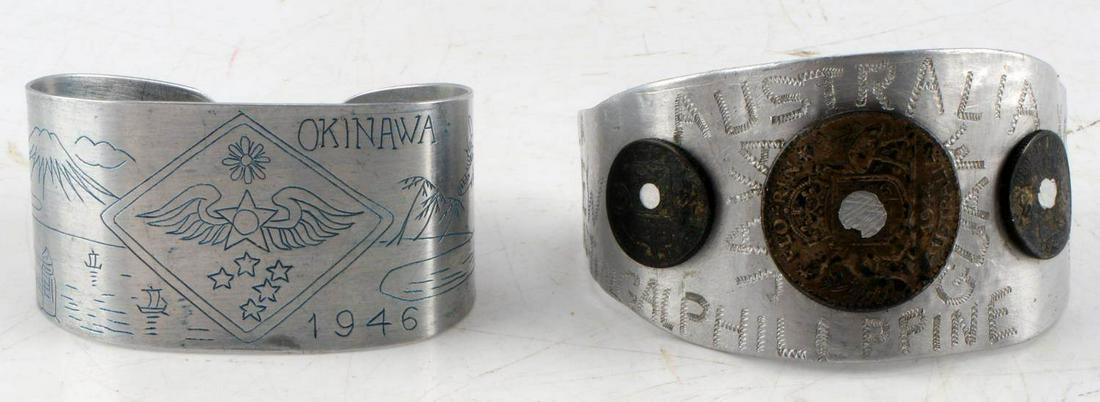 POST WWII LOT OF 2 ALUMINUM TRENCH CUFF BRACELETS: One has Australian coins affixed to front and tooled country names all over, dated 1945. One has Okinawa design 1946. Very good condition.