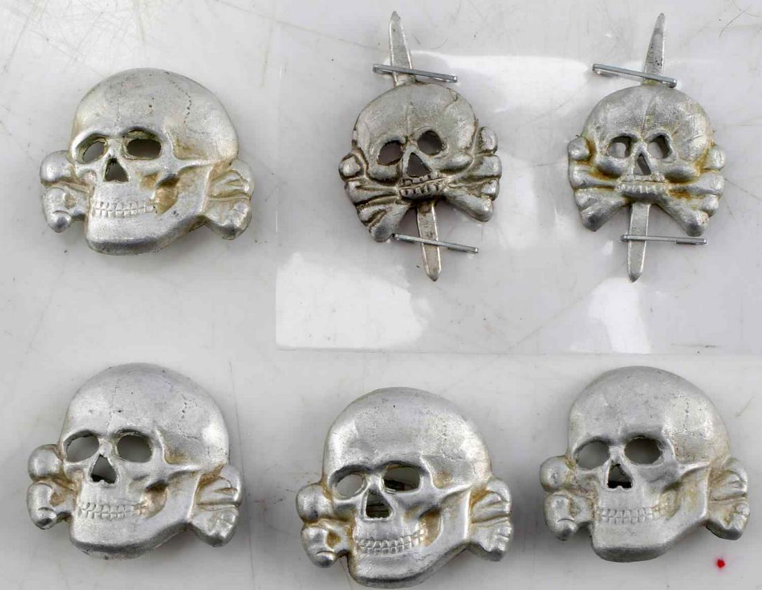 WWII THIRD REICH GERMAN TOTENKOPF INSIGNIA PANZER: Six Totenkopf insignia: four badges measuring 1 inch, and two Panzer insignia measuring .75 inches.Unauthenticated, sold as is.