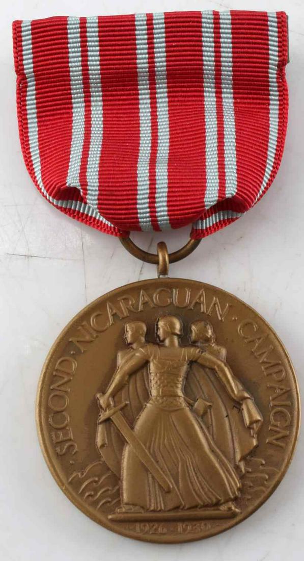 US NAVY 2ND NICARAGUAN CAMPAIGN MEDAL WITH BOX: Design in relief to both sides, M. No. 9042 marked to rim, red with grey stripes ribbon, comes in original box. Very good condition.