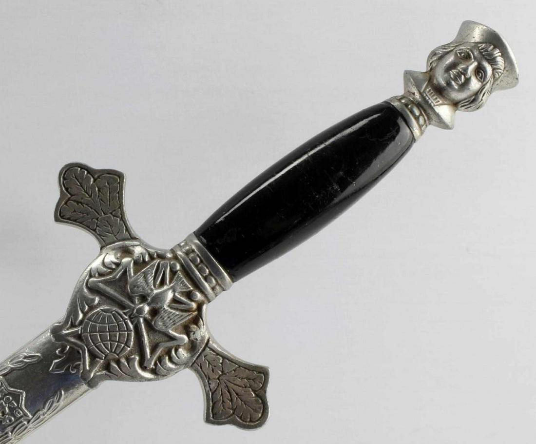 KNIGHTS OF COLUMBUS DRESS SWORD W SCABBARD: Features a 25 5/8 inch blade with sharp tip, leather washer, all-white metal fittings, black grip, Elly Utica, NY marked to ricasso, metal scabbard is in good condition. Very good condition.