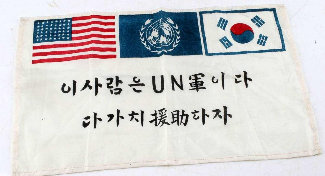 KOREAN WAR BLOOD CHIT SMALL SILK FLAG 1951: Small Korean War flag with flags above and message below. One sided. Reads to back top rim 'Duane sent this from Japan Jan. 19, 1951.' Measures 13.75 X 8.5 inches. Very good condition.
