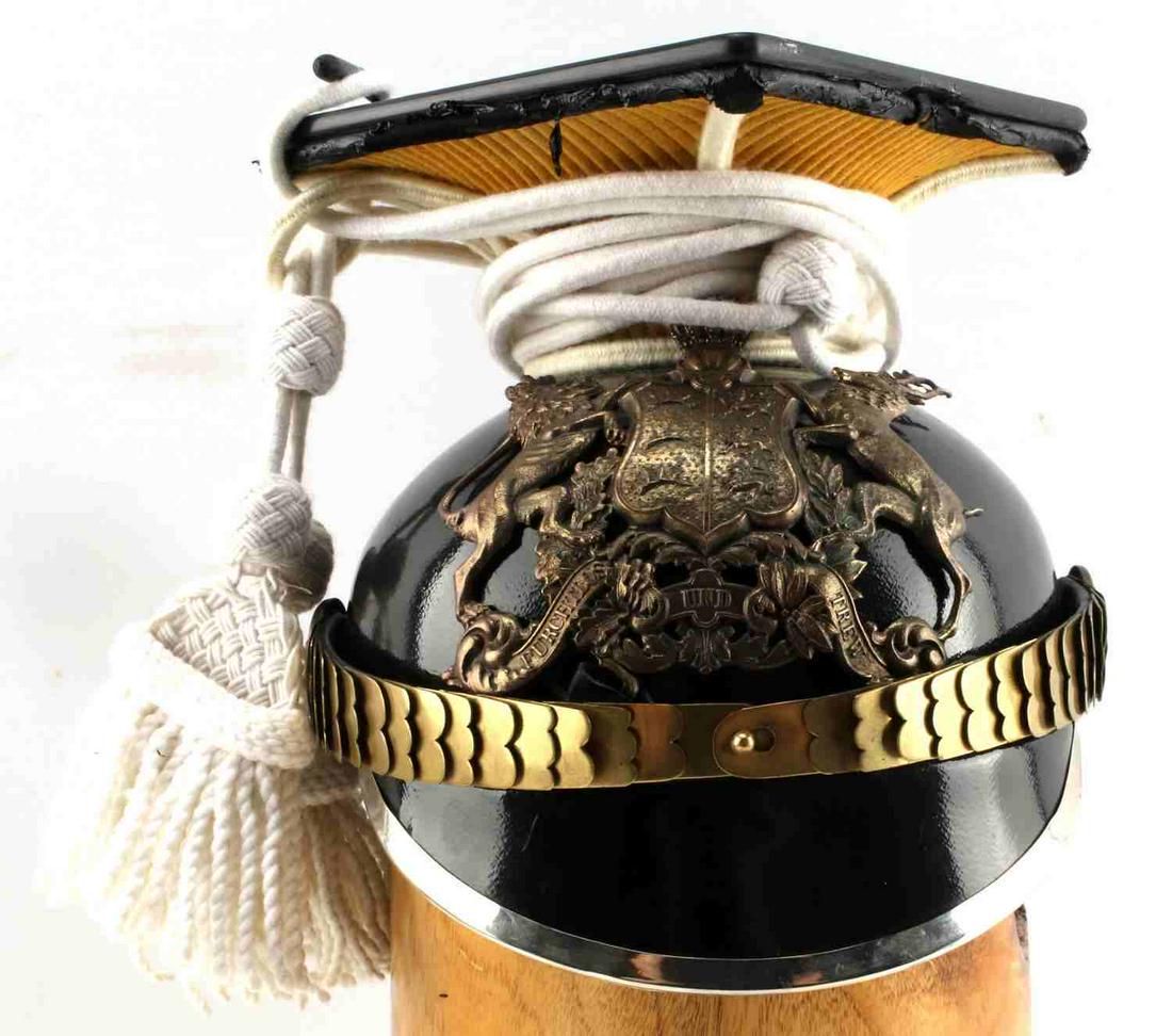 WW1 GERMAN IMPERIAL UHLAN HELMET WURTTEMBERG: Black imperial WWI German Uhlan helmet with tassel. Displays the coat of arms of Wurttemberg on front with the inscription "Furchtlos und trew". Includes tassel and chinstrap.
