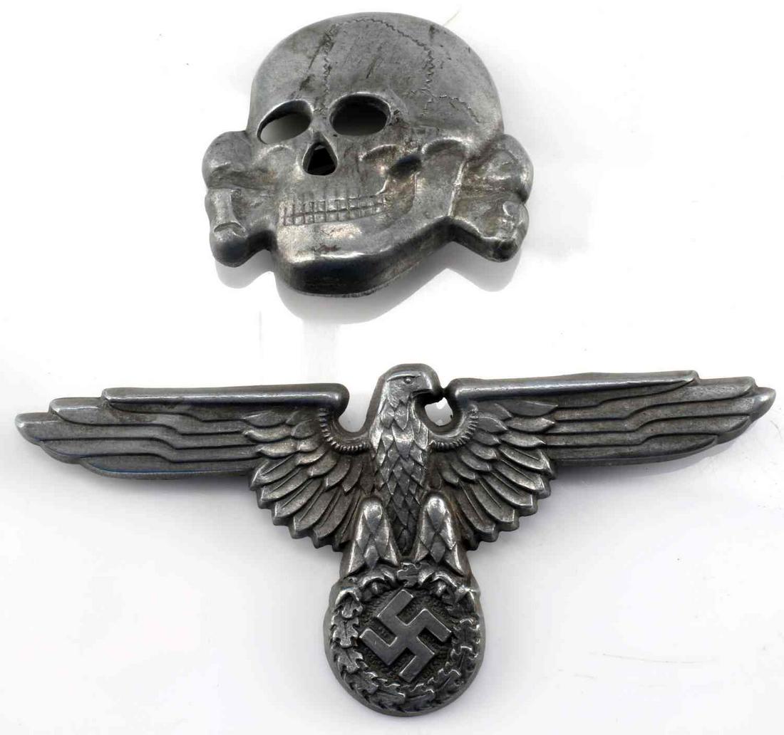 WWII GERMAN SS EAGLE AND SKULL VISOR INSIGNIA: WWII German SS Visor hat insignia matching set in zinc. Both are marked RZM M1/24. In good condition overall. This lot has a reserve.