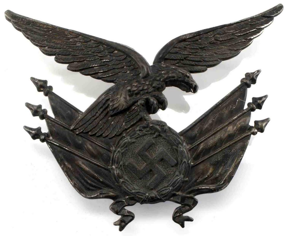 WWII GERMAN THIRD REICH LUFTWAFFE GORGET EAGLE: WWII German Reichsadler and flag emblem off of a Luftwaffe standard bearer's gorget. 3 1/2 inches wide by 2 1/2 inches tall. 4 posts in the back for attachment to the gorget. This lot has a reserve.