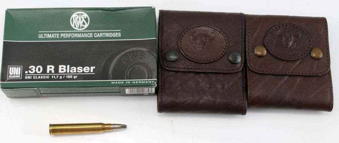 20 ROUNDS OF .30 R BLASER AMMO 2 BULLET POUCHES: This lot includes 20 rounds of .30 R Blaser RWS ammunition, made in Germany. Accompanying the ammo comes two Genuine Cape Buffalo ammunition pouches which hold 10 bullets each.