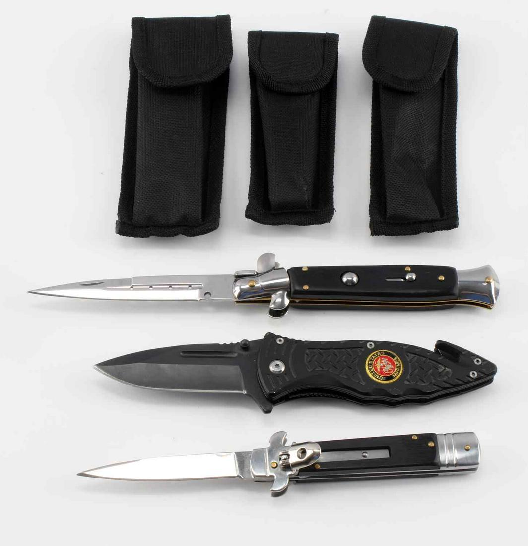 ASSORTED POCKET KNIFE & SWITCH BLADE LOT OF THREE: Lot includes a modern USMC Spring Assisted pocket knife and two modern switch blades with their own individual carrying cases. USMC knife measures 8 inches fully extended. Also includes a flip tab swi