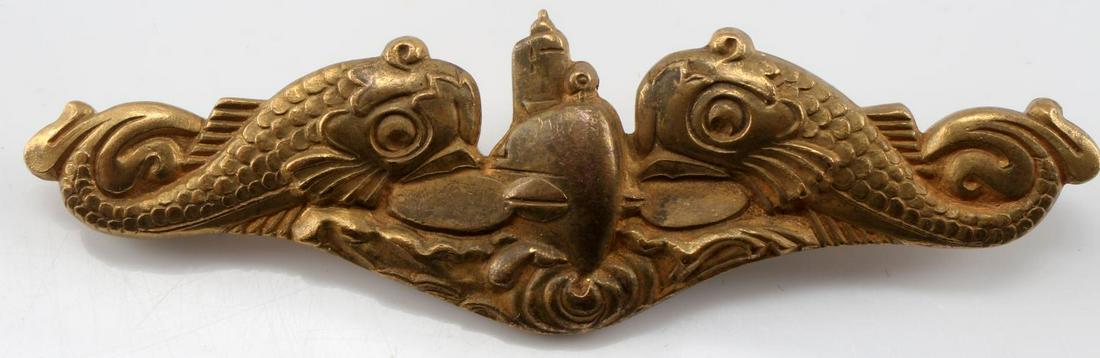 USN WWII NAVAL SUBMARINE OFFICERS DOLPHIN BADGE: Australian Made. Measures 2 3/4" wide by 2 15/16” wide by 15/16” tall. The front shows a submarine in the center flanked by a dolphin on each side. The reverse is maker marked ‘Wallace Bishop Br