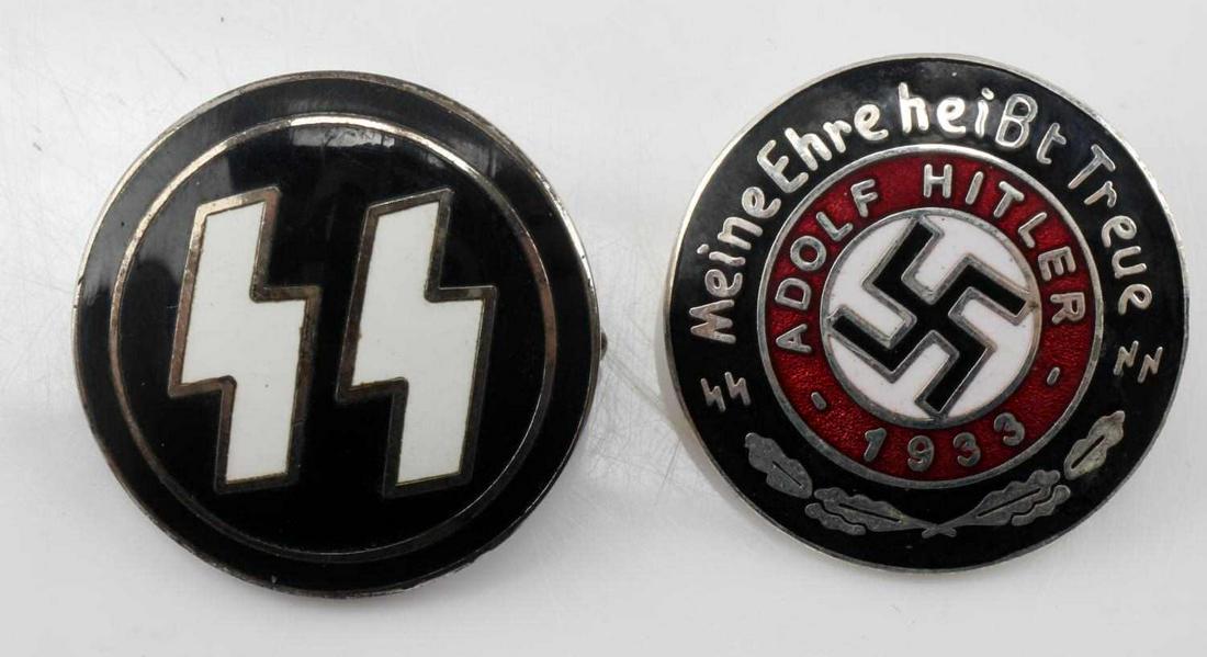 GERMAN WWII WAFFEN SS RUNIC MEMBERSHIP BADGE LOT: Lot includes two badges. (1) Measures 15/16” in diameter. The front shows a pair of Waffen SS runics in the center. The reverse side is maker marked ‘RZM M1/4 ges gesch’. (2) Waffen SS Adolf Hit