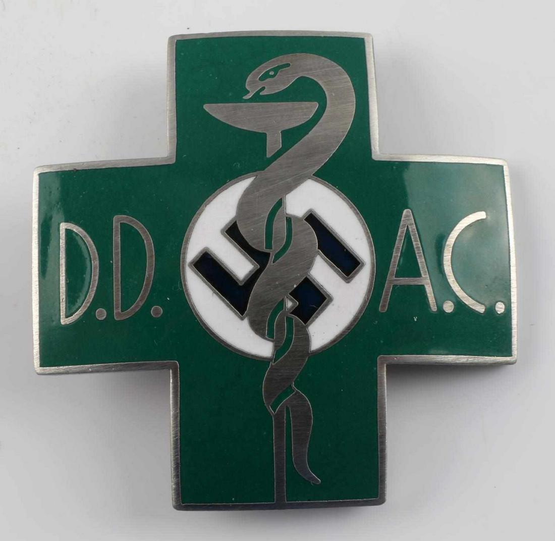 WWII GERMAN MEDICAL DOCTOR DD AC BREAST BADGE: WWII German Medical Doctor DD AC Caduceus Breast Badge. Measures 1 7/8” wide by 1 7/8” tall. The front reads ‘D.D. A.C.’. It shows a snake wrapped around a drinking beaker with a swastika in t