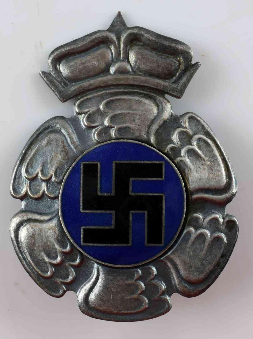 WWII GERMAN FINLAND AXIS COMBAT BREAST BADGE: WWII German Finland Axis Combat Breast Badge. Measures 1 3/4" wide by 2 3/8” tall. The front shows a swastika in the center round winged back ground. Has a screw mount post and nut on the reverse si