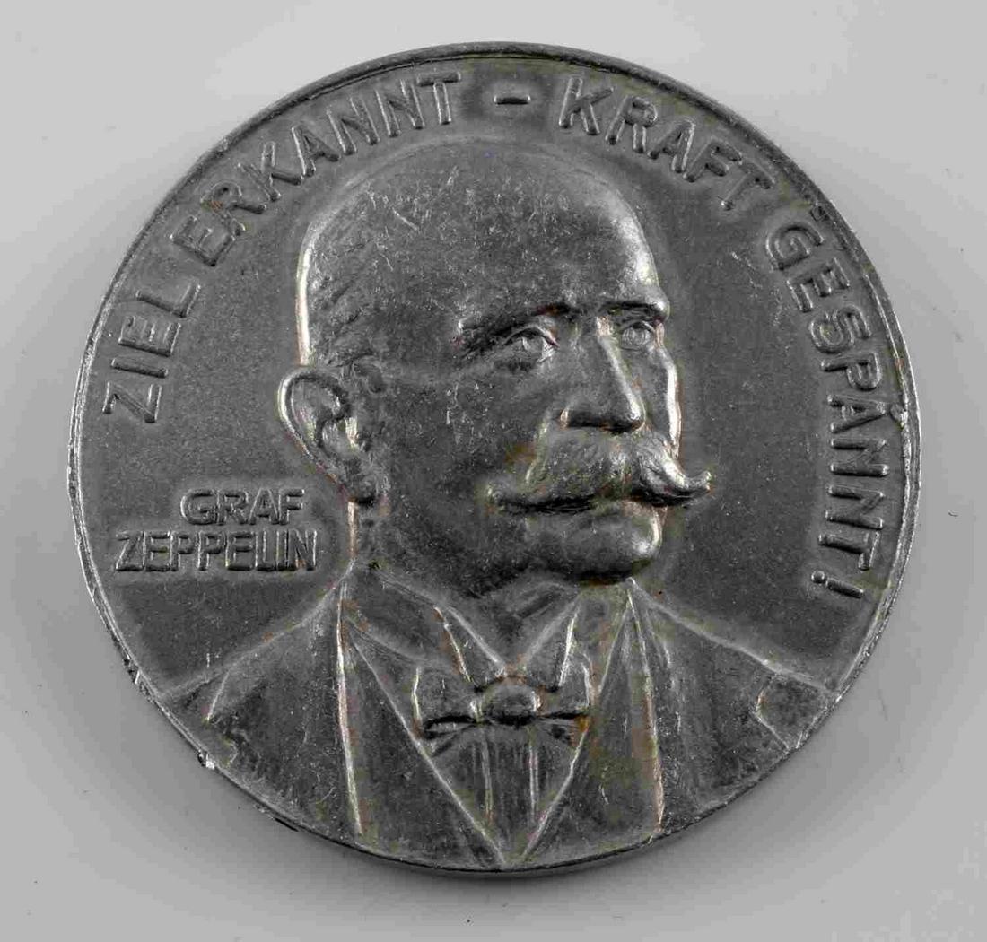 IMPERIAL GERMAN PRE WWI ZEPPELIN SOUVENIR COIN: Imperial German Pre WWI 1908 Graf Zeppelin Souvenir From Crashed Air Ship. Measures 1 5/16” in diameter. The front shows a bust image of Graf Zeppelin in thecenter. It reads ‘Ziel Erkannt – Kraf