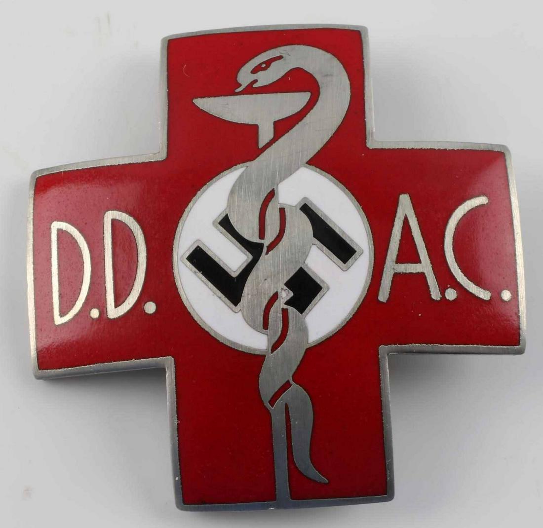 WWII GERMAN MEDICAL DOCTOR CADUCEUS BREAST BADGE: WWII German Medical Doctor DD AC Caduceus Breast Badge. Measures 1 7/8” wide by 1 7/8” tall. The front reads ‘D.D. A.C.’. It shows a snake wrapped around a drinking beaker with a swastika in t