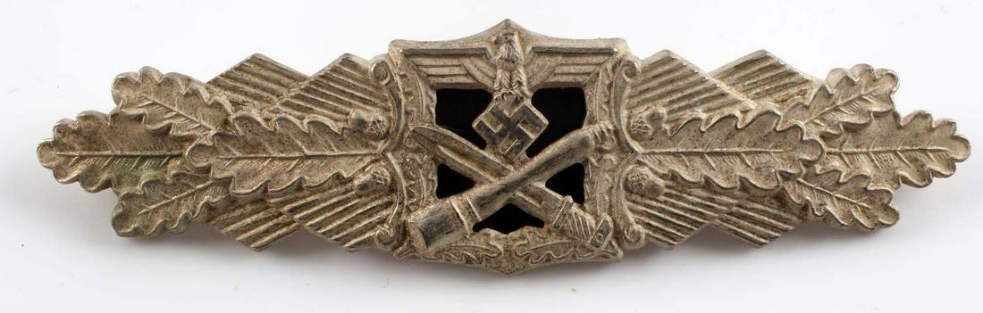 WWII GERMAN ARMY SILVER CLOSE COMBAT CLASP: WWII German Army Silver Close Combat Clasp. The front shows a German eagle clutching a swastika in his talons. There is a crossed bayonet and potato masher stick grenade at the base. All three are fla